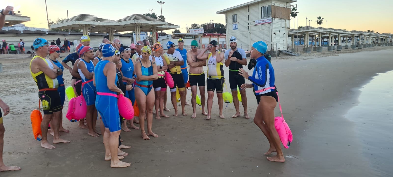 Audrey coaching a group of open-water swimmers on the beach
